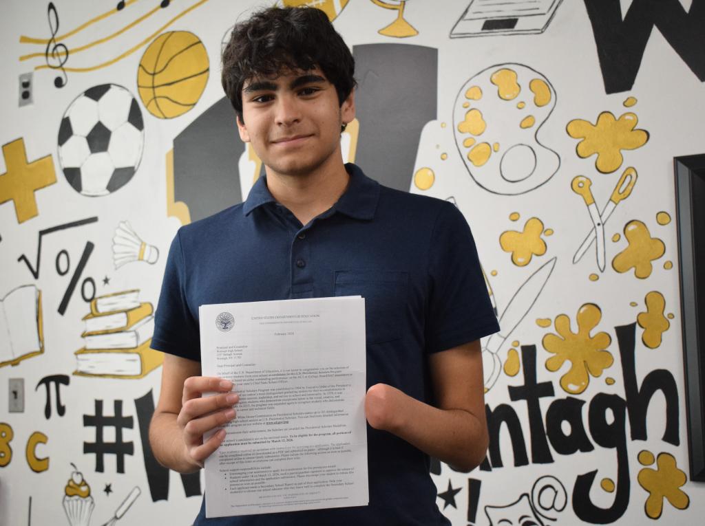 student holding certificate